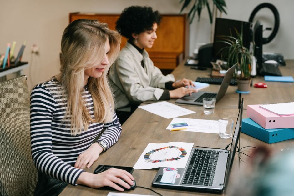 Team collaborating at laptops in an office